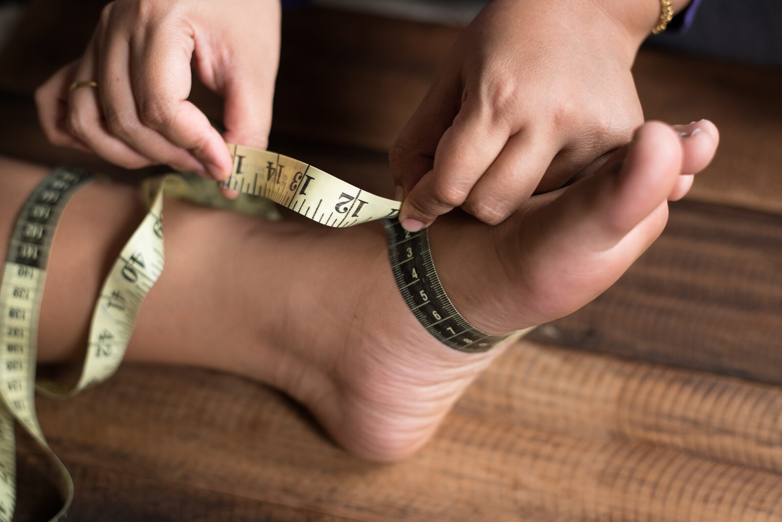 Measuring a foot with a tape measure