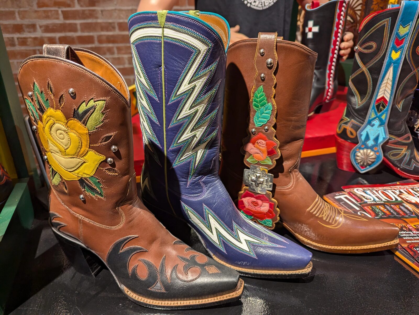 Boots with inlay and overlay leather work on display at Rocketbuster