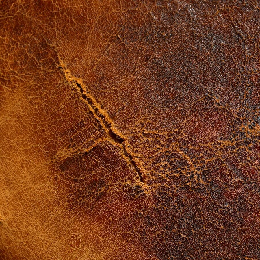 A scratch and gouge in leather before repair
